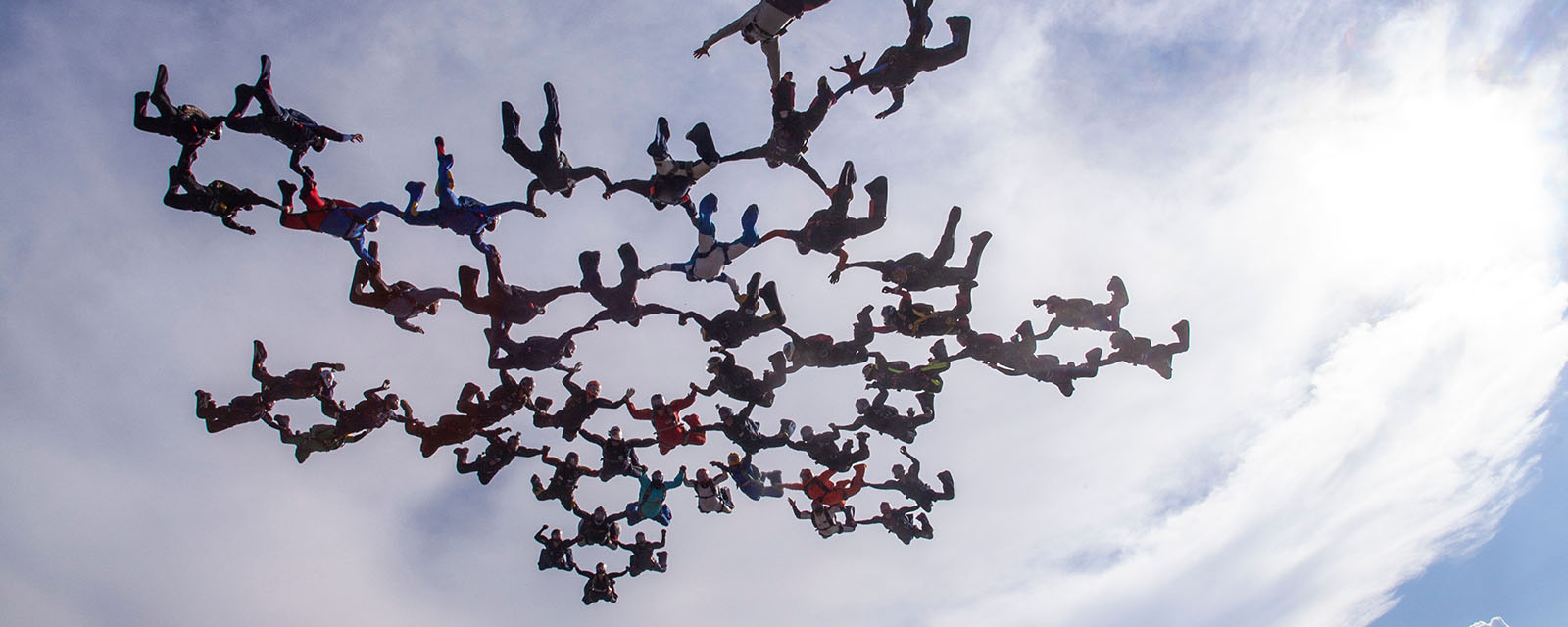 Big skydive formation at cloudy sky, togetherness concept.